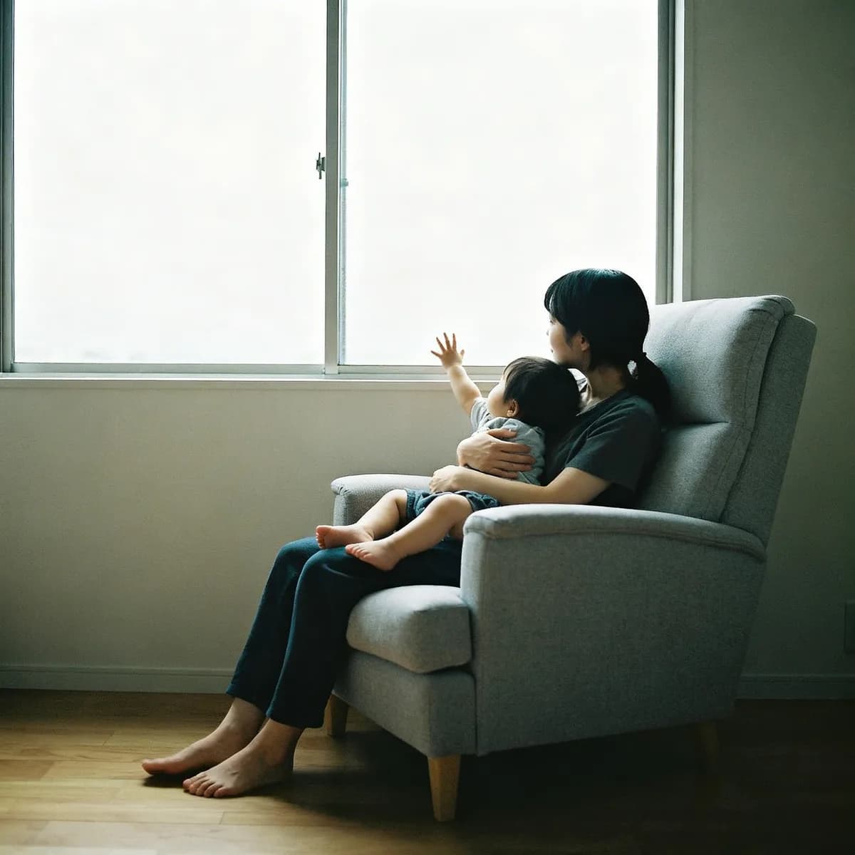 Korean mother holding toddler by window, illustrating separation anxiety and secure attachment in babies