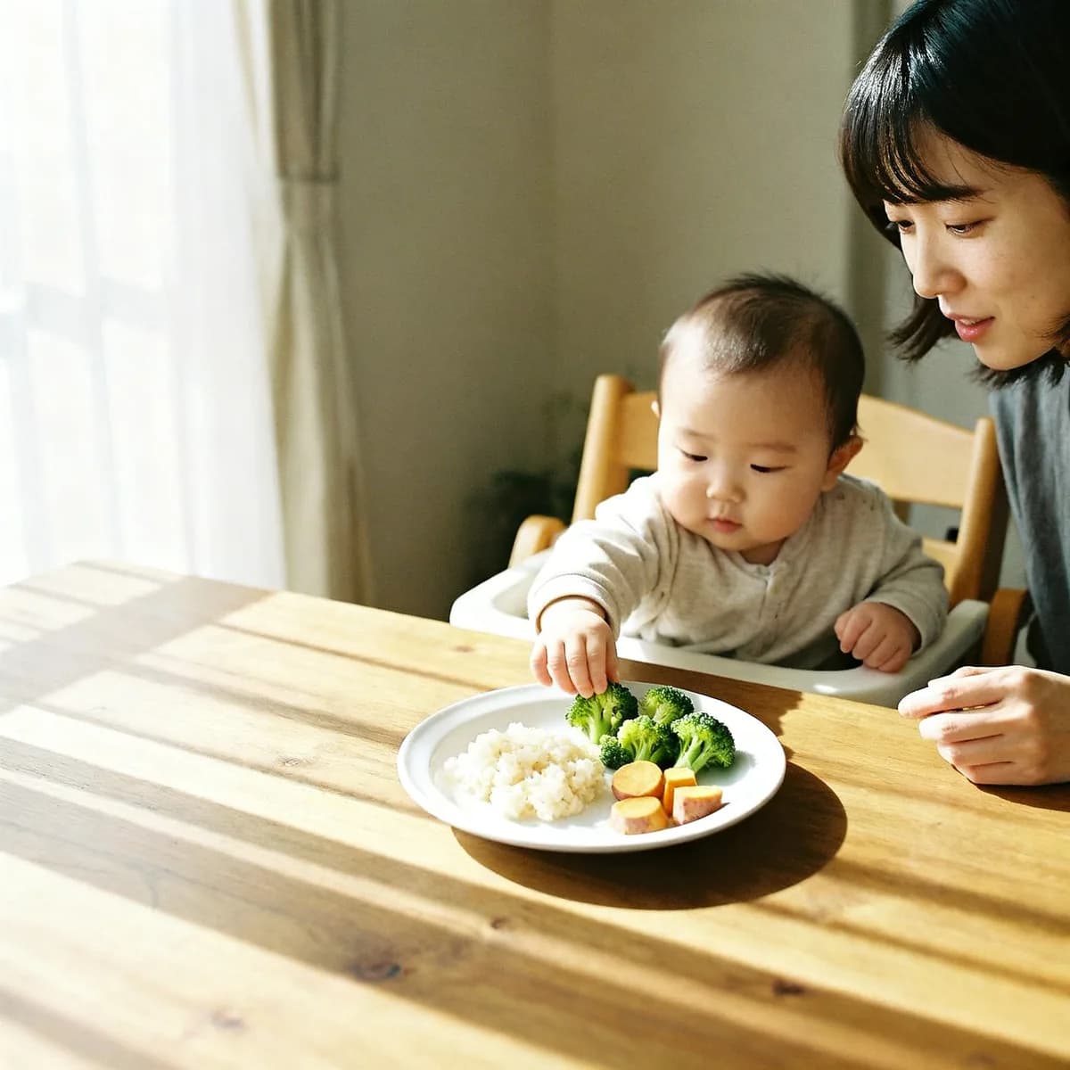 Korean mother watches baby reach for table food during feeding milestone moment